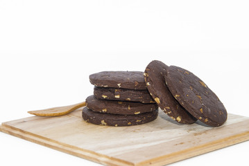 Stacked chocolate chip cookies on wood tray in background