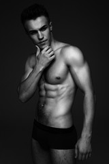 Fototapeta na wymiar Young fashion topless man isolated on dark background