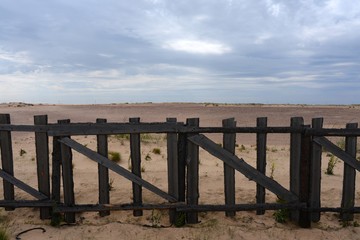wooden fence in the sandy desert