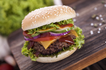 Beef burgers on a wooden board with aromatic spices