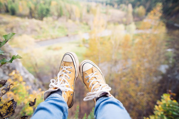 legs on mountain peak rock