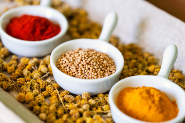 Aromatic herbs on bed of dried chamomile flowers.
