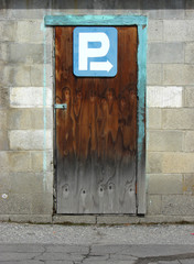 
Parking directions sign on old wooden door