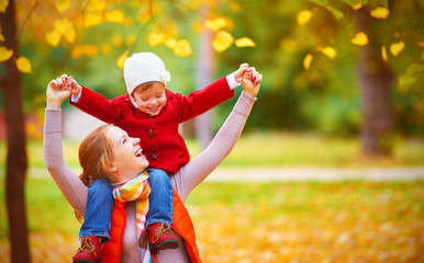 happy family: mother and child little daughter play cuddling on