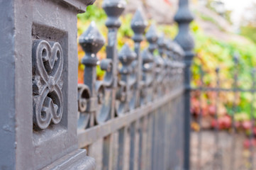 Metal fashion fence, column with pattern and blurred background