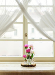 Flower composition with pink peonies / Beautiful flower arrangement near the window for an event, party or wedding 