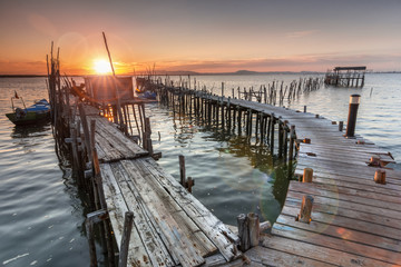 Sunshine from a sunset on a old pier - 91360952