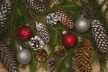 Christmas background. spruce branches with cones, Christmas balls toys