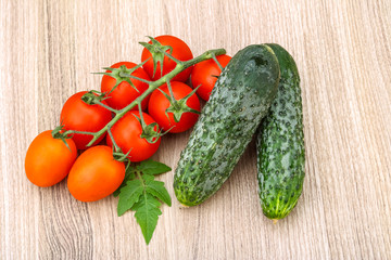 Cucumbers and tomatoes on the branch
