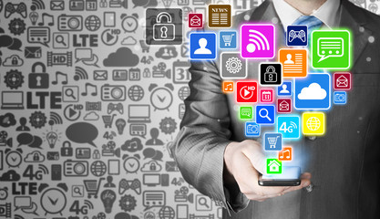 Obraz premium Business man using smart phone with social media icon set