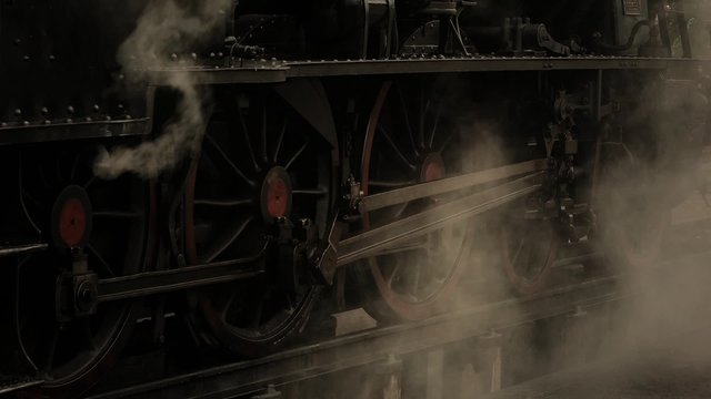 Close up on wheels of old steam locomotive