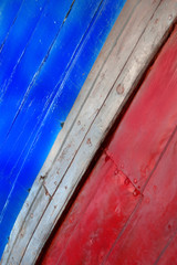 Restoring an aged wooden boat.  Wooden sea background representing the pass of the time. 