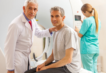 Patient undergoing mri scan with doctor assistance