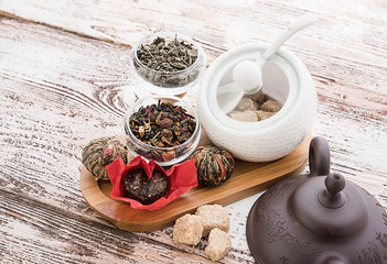 Tea cups with teapot on old wooden table