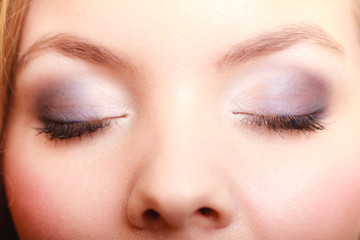 Closeup beautiful female eyes with make-up visage.