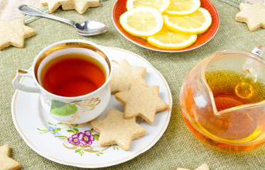 Homemade star cookies with tea and lemon