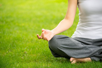 woman meditating and Yoga in a park