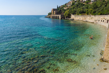 Shipyard (Tersane) and the ruins of a medieval fortress (Alanya Castle) on the mountainside. Alanya. Turkey.
