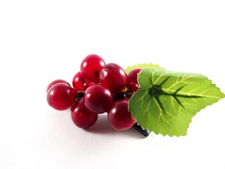 Plastic grape fruit on black hairpin, decorated with artificial leafs, hair accessory, isolated on white background