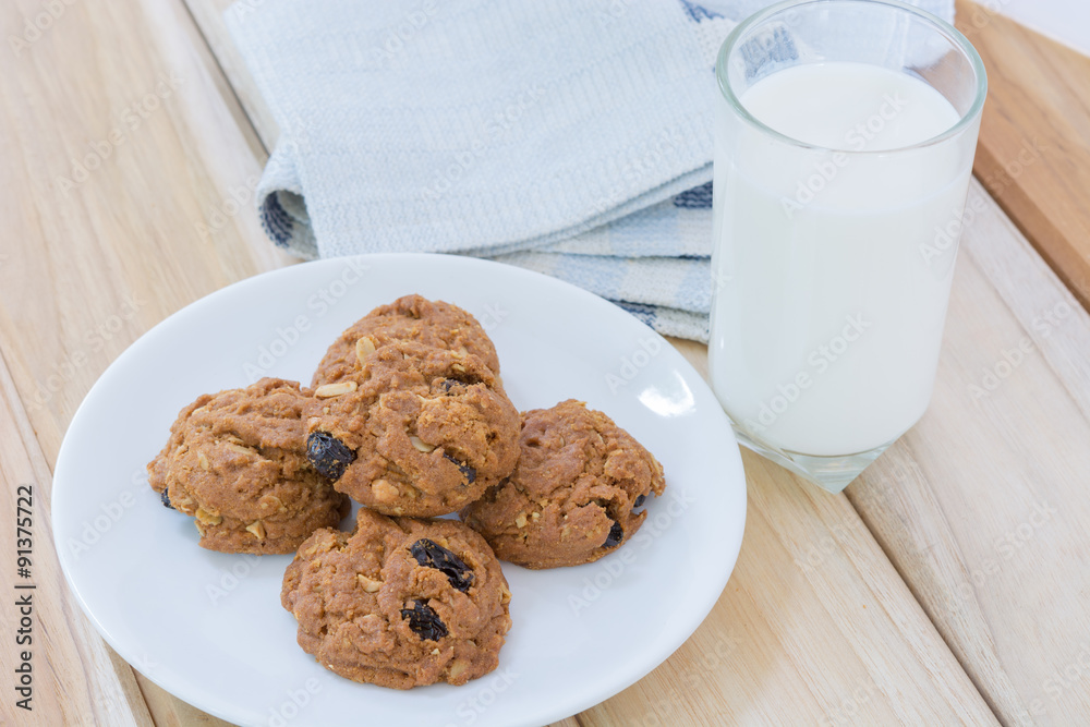 Poster delicious raisin cookies and a glass of milk