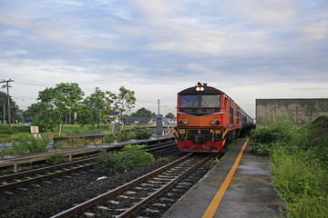 Fototapeta premium Suburb train in Thailand and clouds