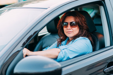 Fototapeta na wymiar Beautiful woman driving her car