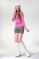 Full body young girl wearing a white beret in white boots posing
