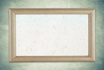 Fototapeta premium Blank wooden picture frame on grunge cement wall background
