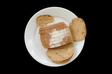 Baked bread on a white plate, Black Background isolated