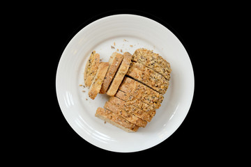 Baked bread on a white plate, Black Background isolated
