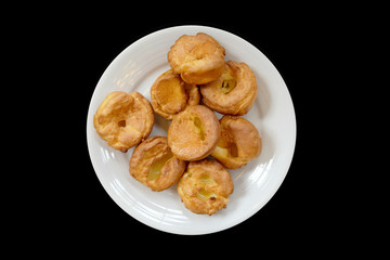 Baked bread on a white plate, Black Background isolated