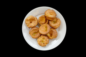 Baked bread on a white plate, Black Background isolated