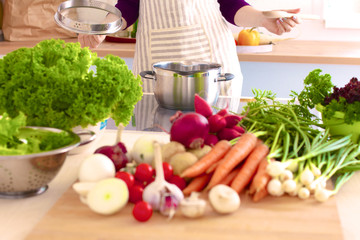 Young Woman Cooking in the kitchen. Healthy Food