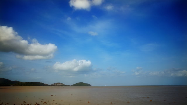 Low tide at ocean shore is baring dirty botom with sparse stones. Timelapse FullHD 1080p.