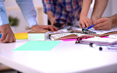 Obraz premium Close-up of three young creative designers working on project