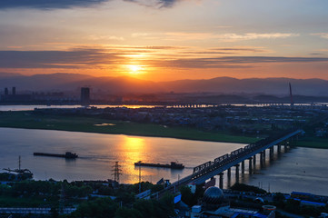 Fototapeta premium City at dusk, aerial view of the bridge.