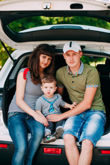 Happy family sitting in the car