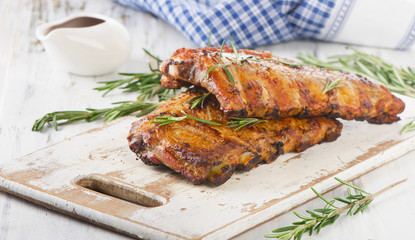 Grilled pork ribs  on a wooden cutting board.