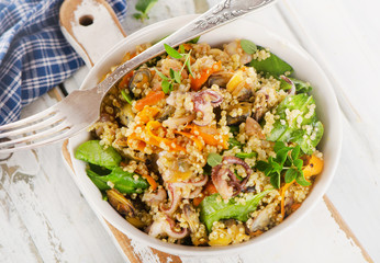 Salad with quinoa and seafood in a bowl.