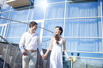 bride and groom on the background of  yacht club, young happy