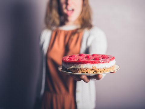 Young woman with cheesecake
