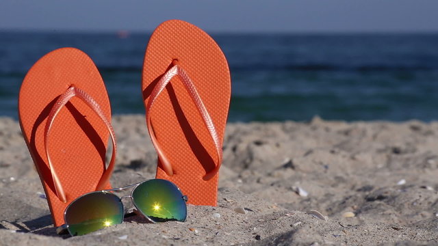 Flip-flops and glasses on the beach