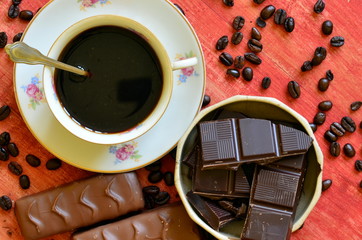 Different chocolate bars and coffee beans and peels of chocolate