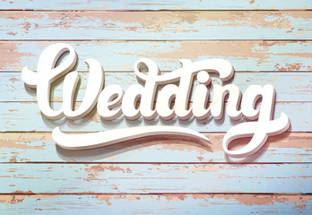 The word Wedding on a wooden background. Wedding invitation vintage card