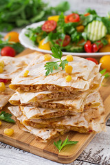 Mexican Quesadilla wrap with chicken, corn and sweet pepper and fresh salad.