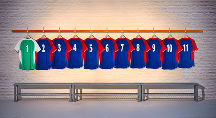 Row of blue and Red Football Shirts hanging on Wall in Changing Room with Bench