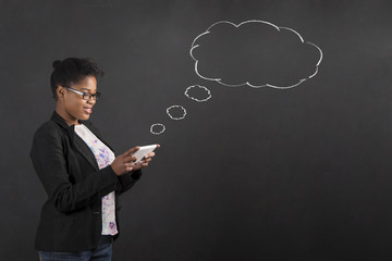 African woman with tablet speech or thought bubble on blackboard background