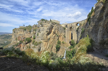 Fototapeta na wymiar The waterfall and the bridge of Ronda