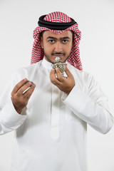 Portrait of Arab man smelling perfume.