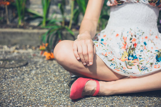 Young woman sitting in meditation pose outside